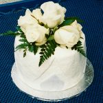small cake with white roses on top