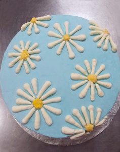 photo of a cake with daisies