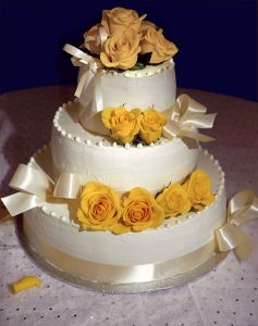 photo of a cake with yellow roses