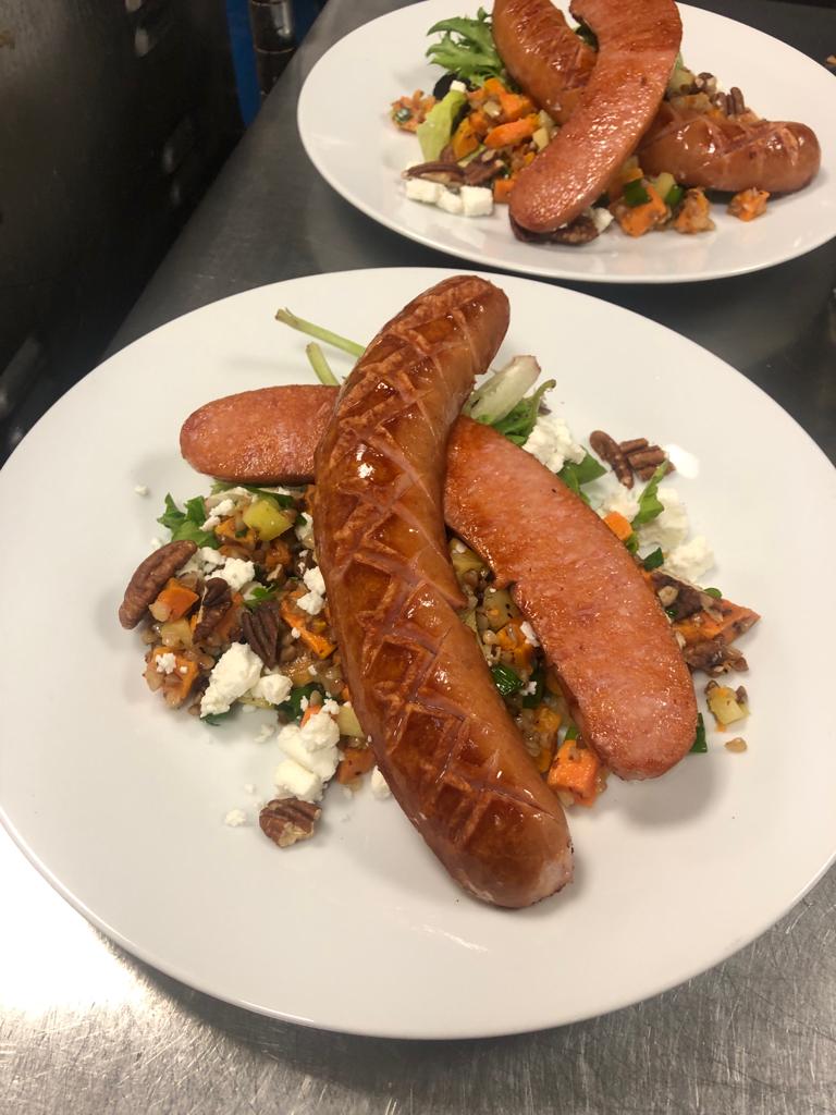 image of seared sausage on sweet potato buckwheat and apple salad with goat cheese & toasted pecans