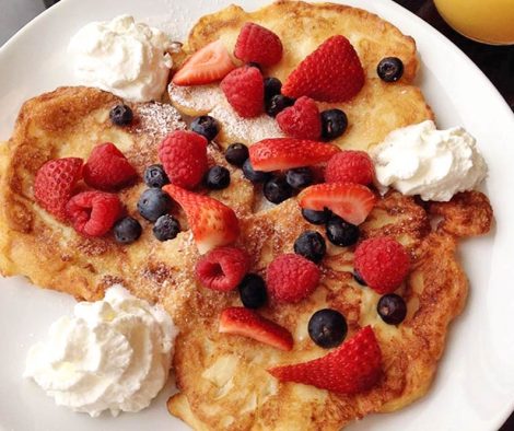 picture of apple pancakes with fresh fruit and whipped cream